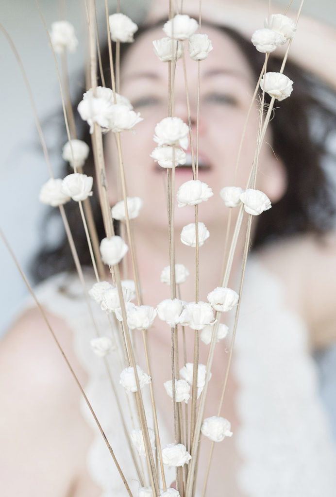 White winter flowers with woman's face blurred in the background