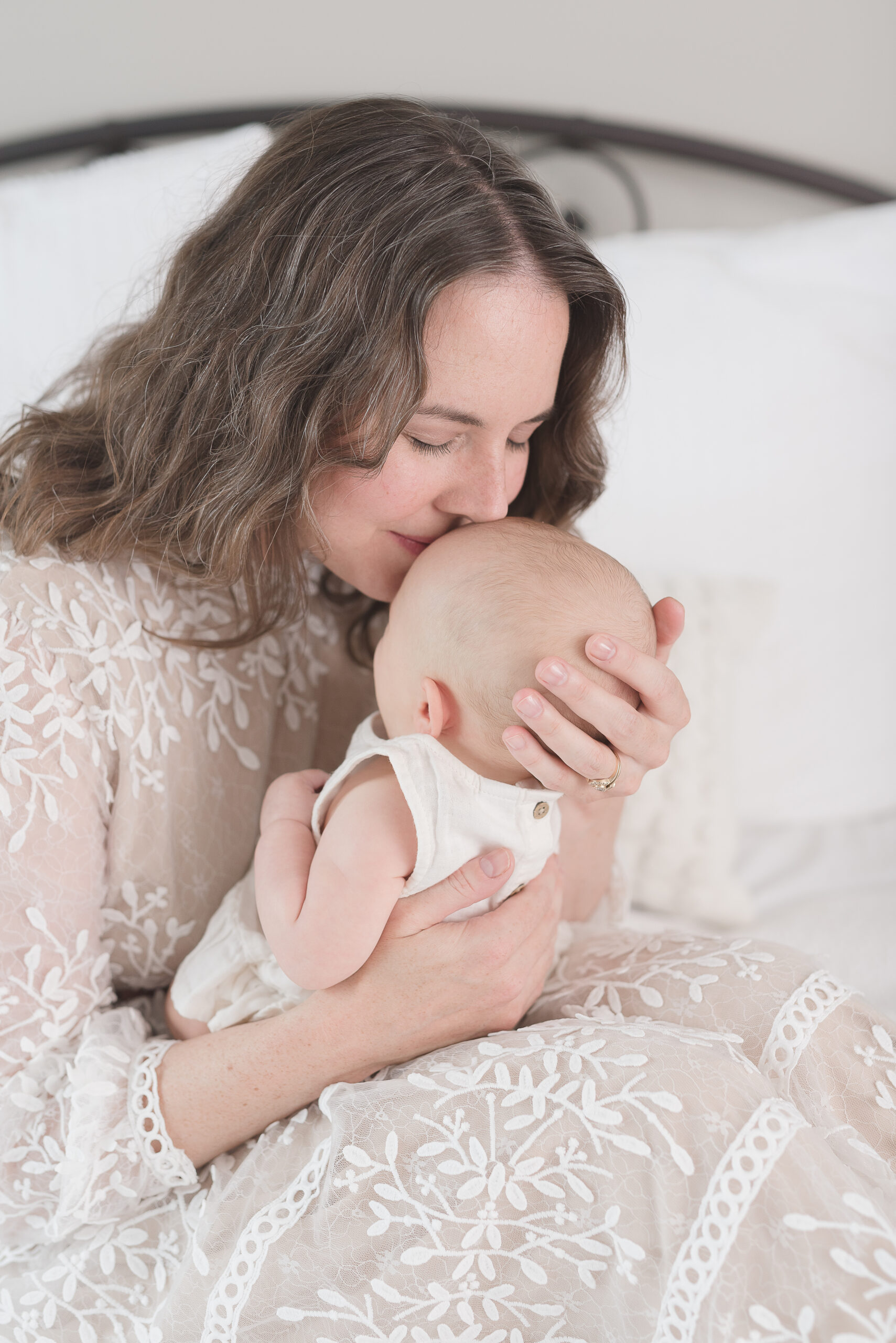 Postpartum doula holding new infant