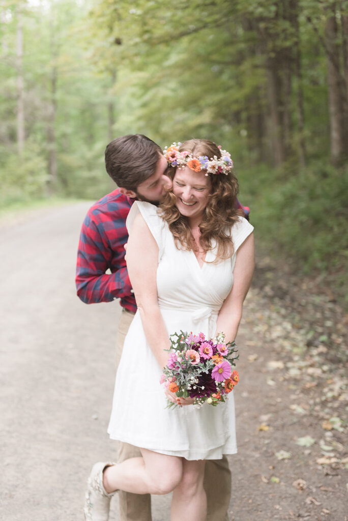 Couple kissing during engagement shoot in the woods of New York in fall