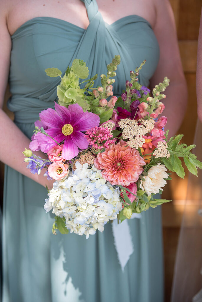 Bridesmaid holding colorful floral bouquet